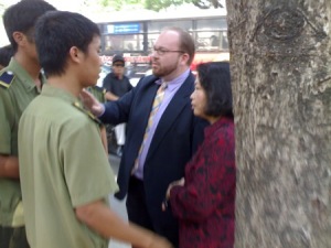 U.S. Embassy representative,  Mr. Christian Marchant, and Mrs. Thuy being harassed in front of the courthouse in Hanoi.